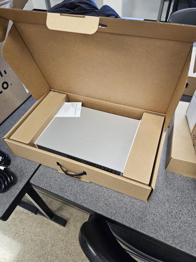 Opened Cisco Meraki switch box showing equipment without anti-static bag or tamper-evident seals